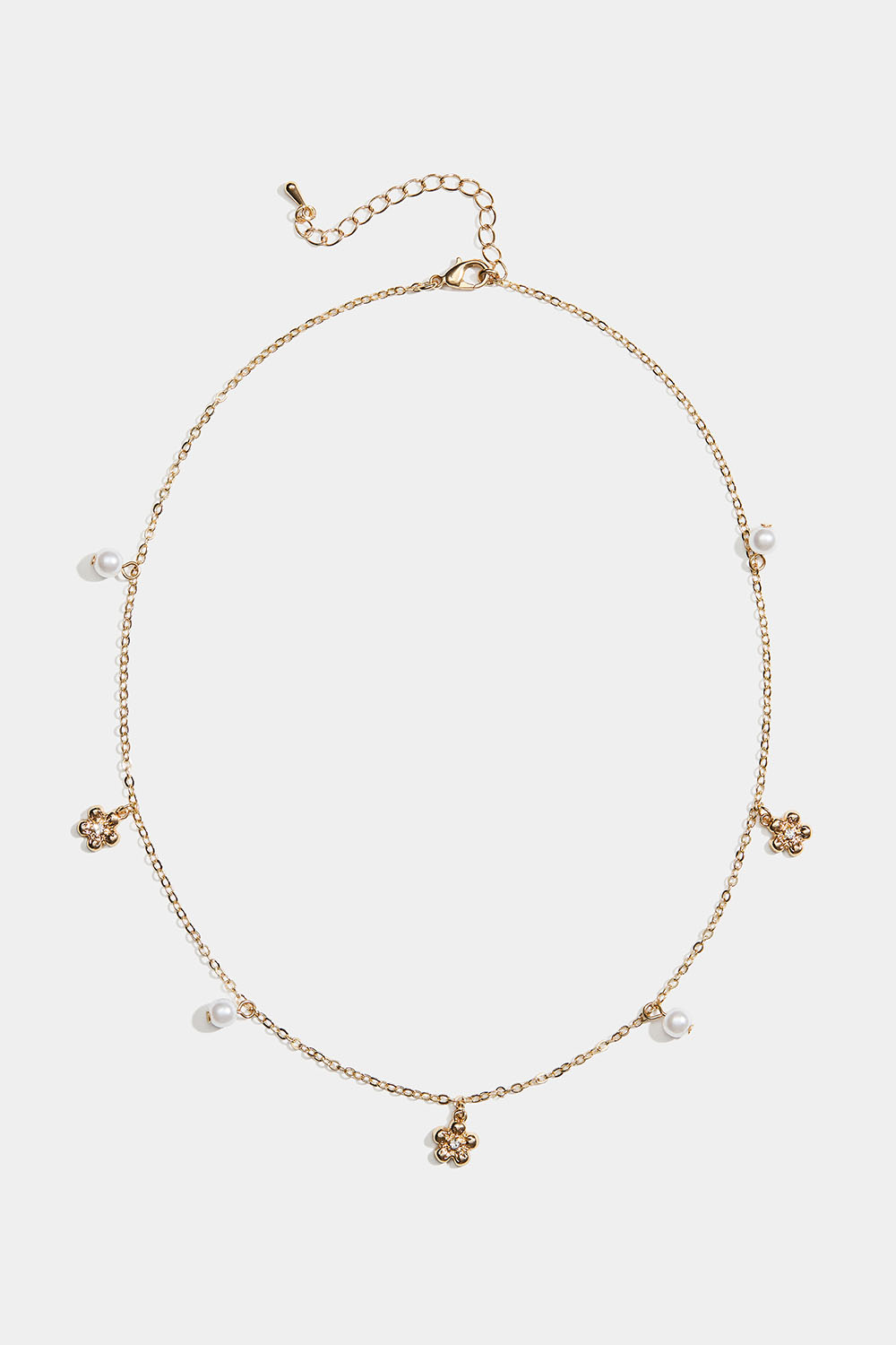 Gullfarget halskjede med blomster og hvite perler i gruppen Store week / hos Glitter (254002572002)