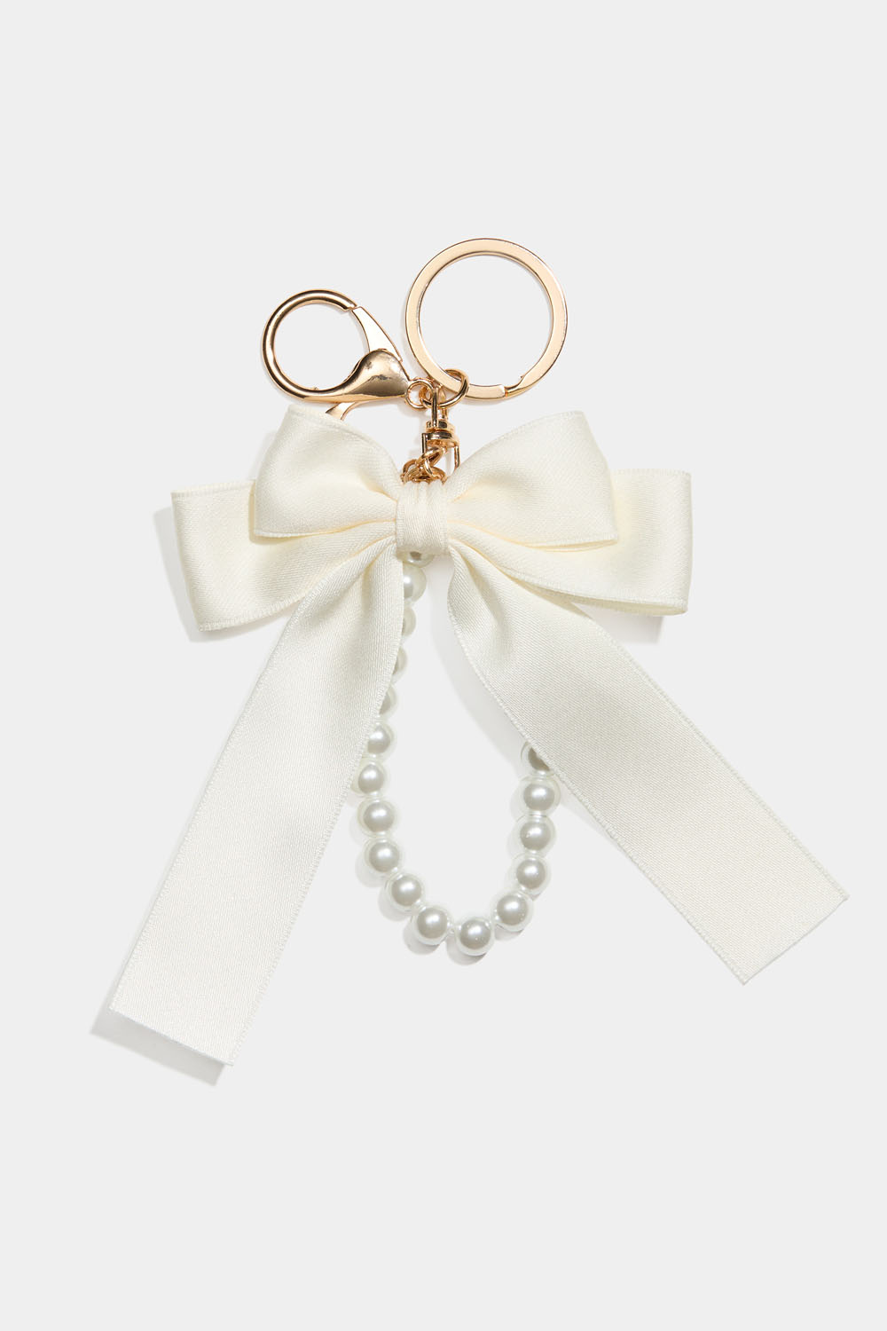 Veskedekor med hvit sløyfe og perlebånd