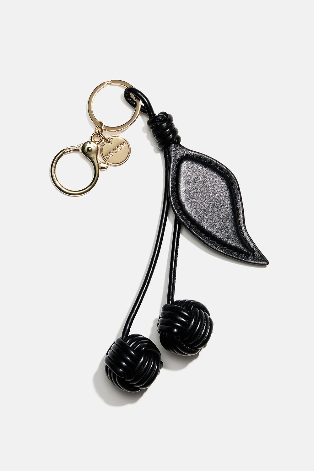 Veskedekorasjon med kirsebær i svart imitert skinn 