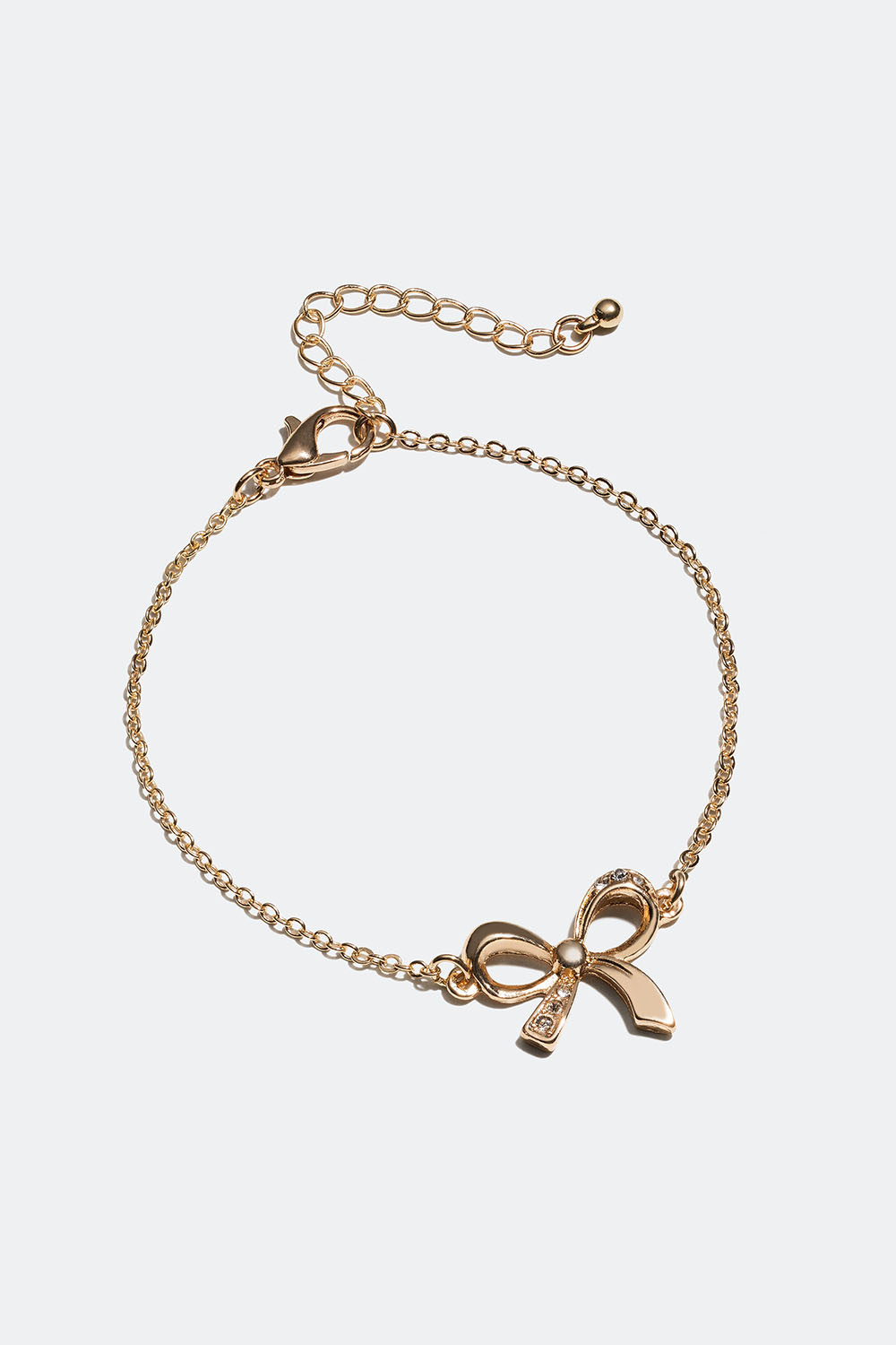 Gullfarget armbånd med sløyfe og glassteiner