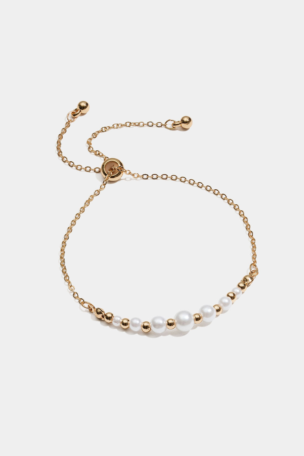Armbånd med hvite og gullfargede perler