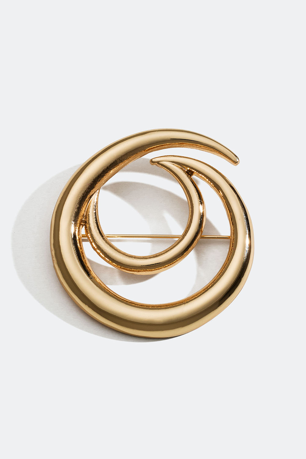 Rund gullfarget brosje