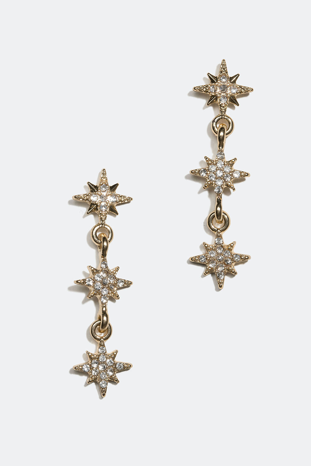 Gullfargede øredobber med små stjerner og glassteiner