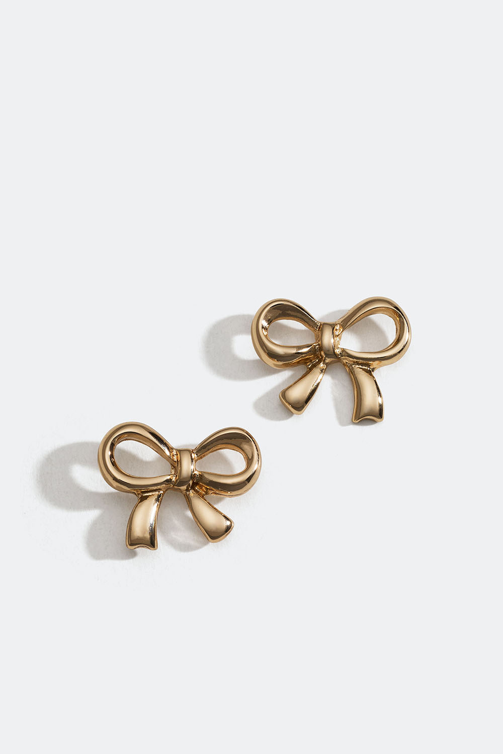 Gullfargede øredobber med sløyfer