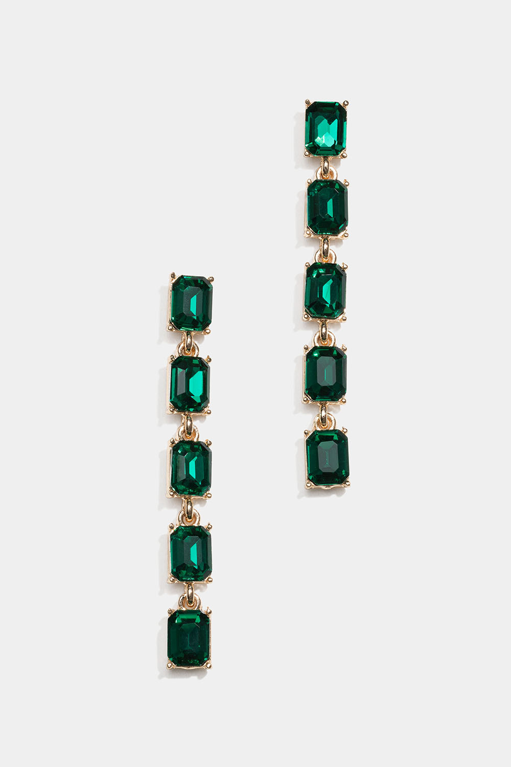 Lange gullfargede øredobber med grønne glassteiner