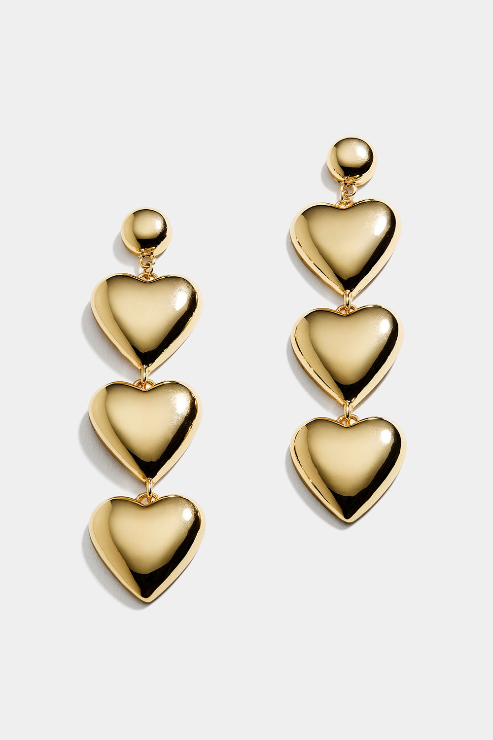 Gullfargede, lange øredobber med tre hjerter
