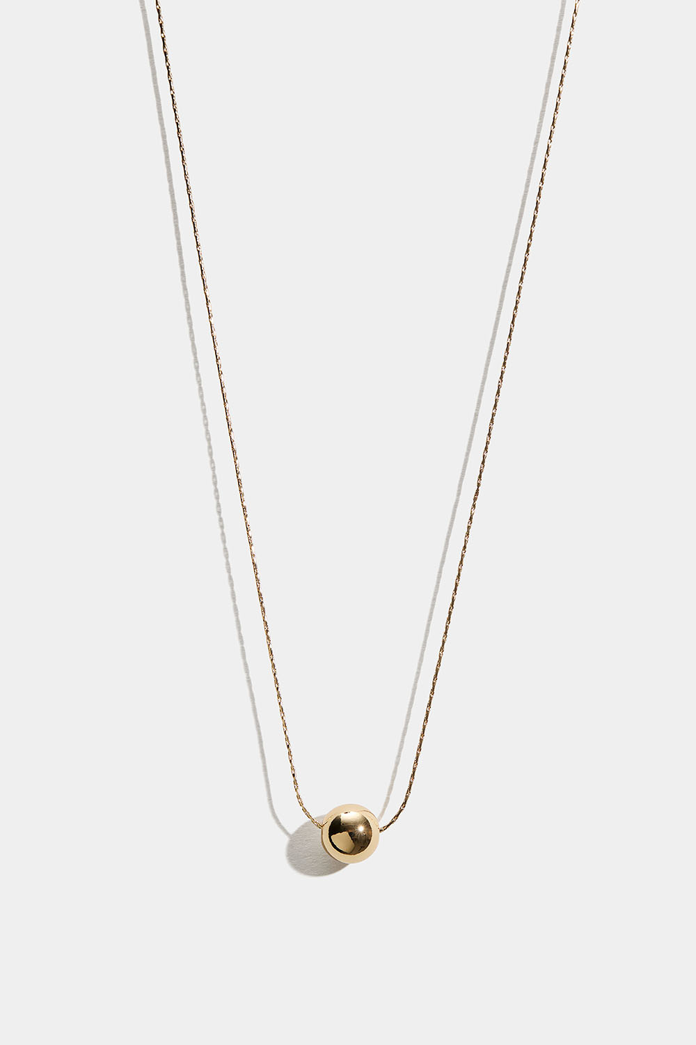 Rundt halskjede med gullfarget perle