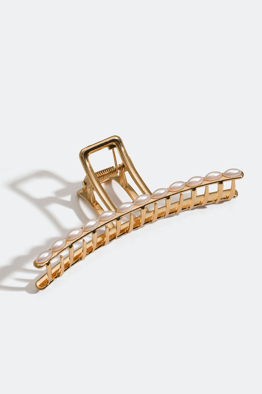 Gullfarget hårklemme med hvite perler