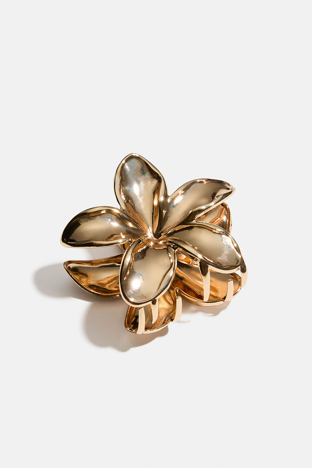Blomsterformet hårklemme i gullfarget metall