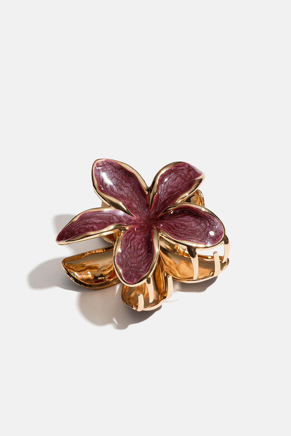 Vinrød blomsterformet hårklemme i gullfarget metall