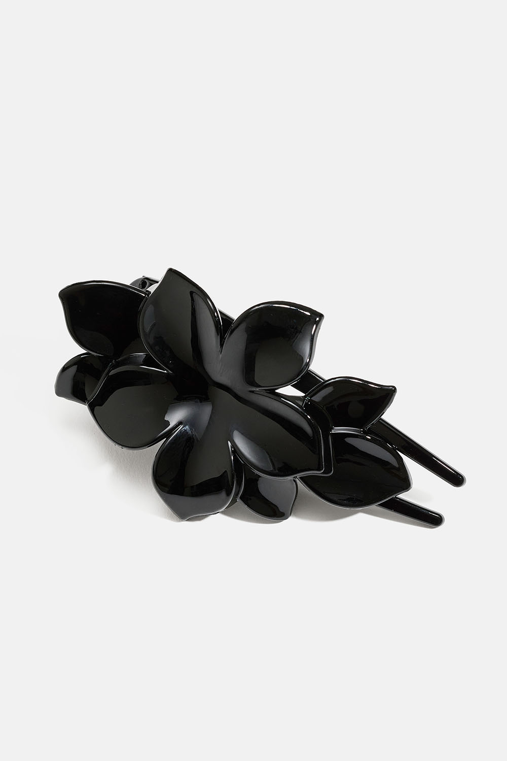 Svart hårspenne med blomst