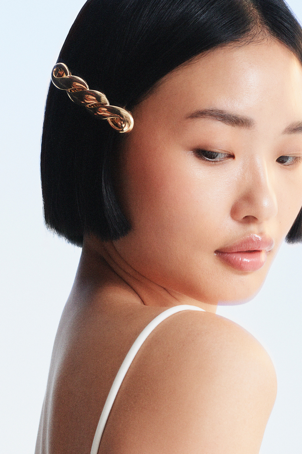 Tvunnet, gullfarget hårspenne