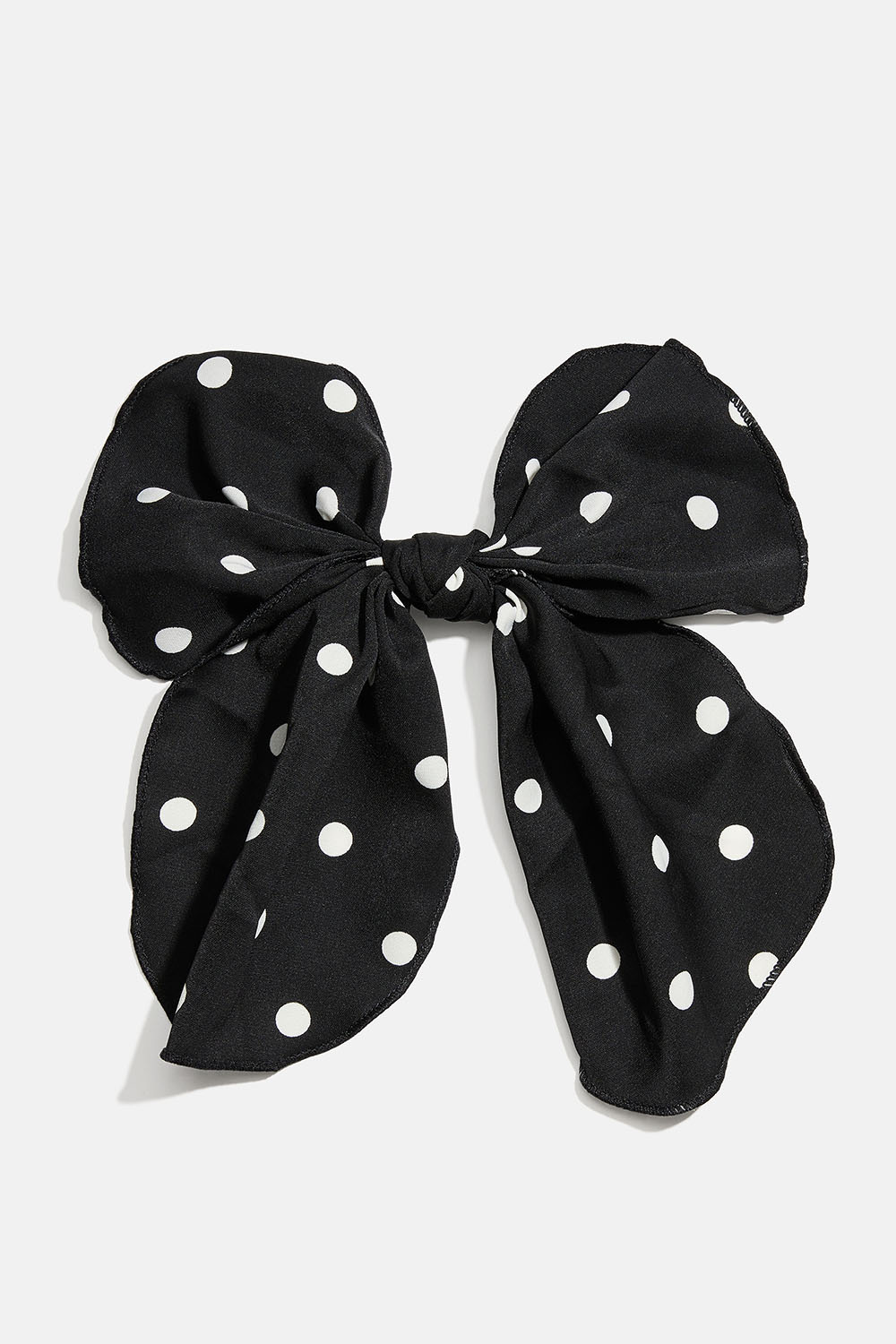 Hårspenne med svart sløyfe i prikkete mønster