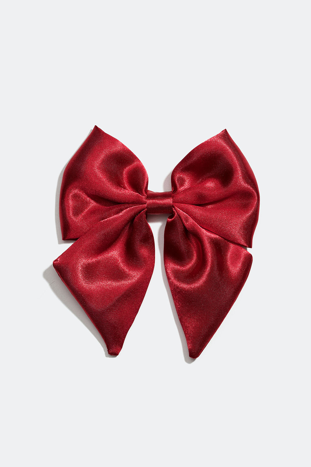 Hårspenne med liten sløyfe i rød, imitert silke.