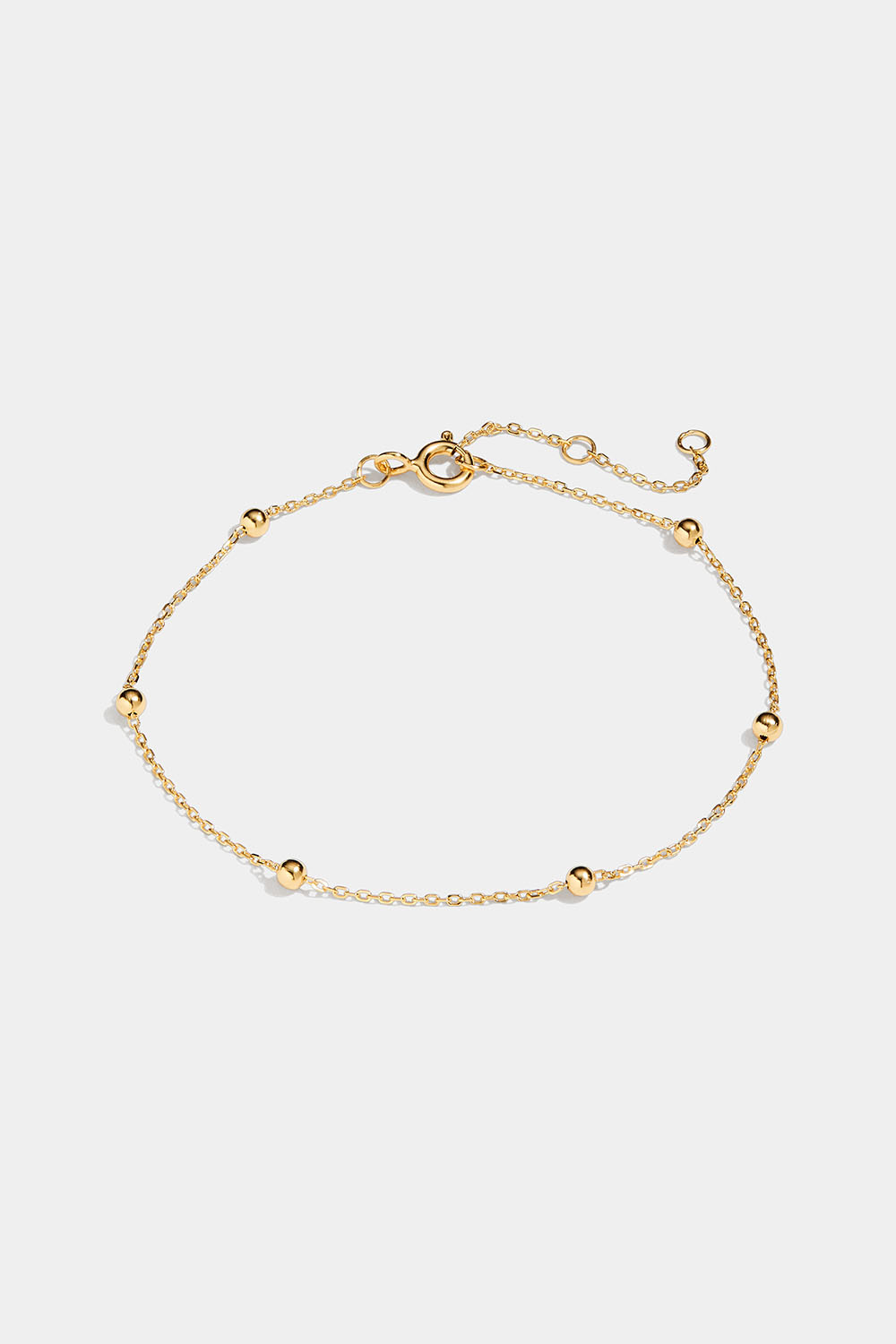 Tynt armbånd med små kuler i 18 k forgylt sølv.